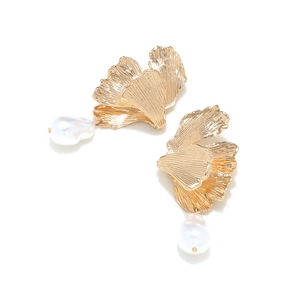 Golden ginkgo leaf earrings with baroque pearls and textured metallic finish on white background
