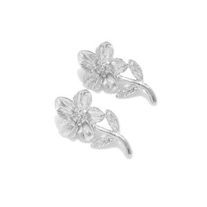 Silver flower stud earrings with wrinkled texture and botanical design on white background