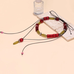 Bohemian multi-layer layered necklace with red resin beads and green geometric charms