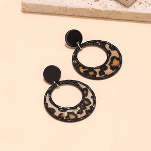 Detail of vintage geometric leopard print hoop earring with velvet flocking texture