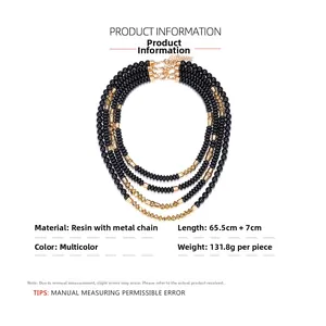 Detail of multi-layer beaded necklace with black resin beads and gold-tone CCB accents