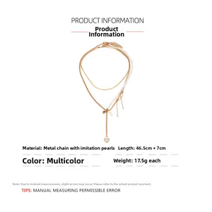Detailed specs of layered baroque pearl necklace with gold heart lock and key charms