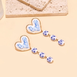 Blue and white ceramic heart earrings with gold frame and floral pattern tassels