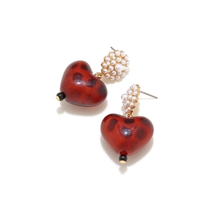 Detail of red leopard print heart earrings featuring clustered pearl floral studs
