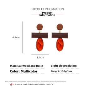 Detail view of retro wood and amber resin drop earrings with 6.1x3.1cm measurements