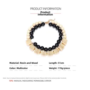 Detail of chunky double-layer necklace with black and beige wood resin beads