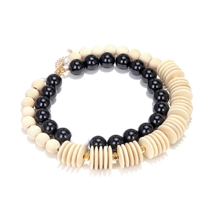 Handmade bohemian necklace with geometric wood beads and black resin stones in retro style