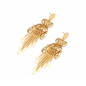 Detailed close-up of golden fringe earrings with hammered metal and drop tassels