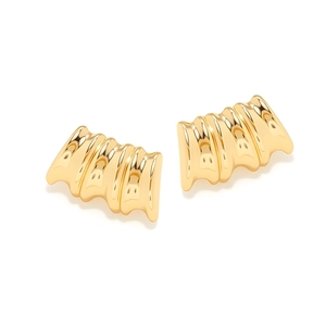 Modern gold irregular geometric stud earrings with polished wavy texture on white background