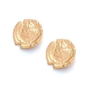 Detail of vintage gold coin earrings with irregular lava texture and embossed heart