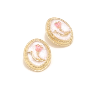 Detailed close-up of vintage oval enamel rose earrings with pink tulip motif and gold trim