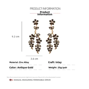 Detail view of retro alloy hollow flower earrings with sparkling rhinestones and size labels
