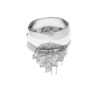 Silver wide open cuff bracelet featuring hammered metal texture and delicate chain tassels