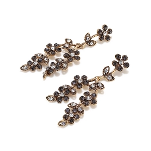 Detailed macro of vintage style flower drop earrings with grey and clear rhinestones