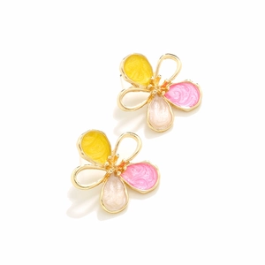 Macro detail of enamel flower earrings with yellow and pink marble texture finish