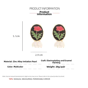 Detail view of rose enamel earrings with faux pearl and precise 5.1cm by 2.9cm dimensions