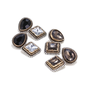 Close-up of vintage geometric earrings with multifaceted black and grey glass stones