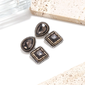 Detailed macro view of vintage geometric earring set with grey glass stones and beaded edges