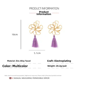 Detailed view of large gold hollow flower earrings with purple fringe and size guide
