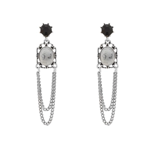 Vintage palace style earrings with black gemstone, cameo portrait, and long silver tassels