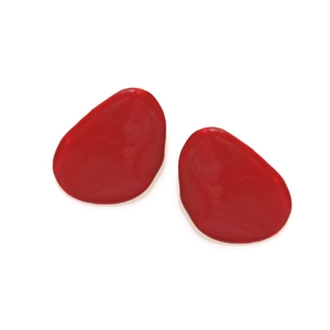 Detailed macro view of glossy red enamel pebble-shaped stud earrings on white backdrop