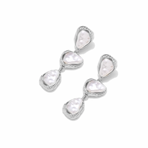 Detail of silver layered baroque pearl earrings with hammered metal texture design