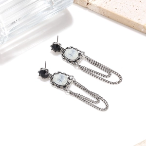 Vintage gothic earrings with portrait relief pendant and silver chain tassels