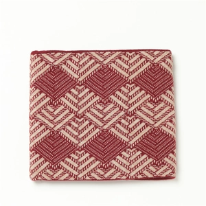 Close-up of red and beige geometric jacquard knit pattern on a thick winter neck warmer