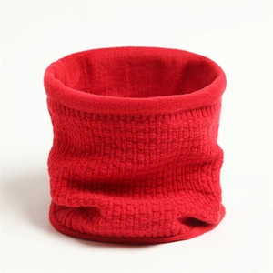 Close-up of red knitted neck warmer with thick checkered pattern and soft fleece lining