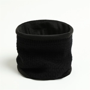Close-up of black knitted neck warmer with vertical stripe texture and plush thermal lining