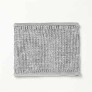 Close-up of gray ribbed knit neck warmer featuring soft faux fur trim and cozy texture