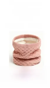 Detail of pink knitted neck warmer showing thick white fleece lining and honeycomb texture