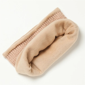 Detailed close-up of thick knitted neck warmer with plush faux fur lining in beige