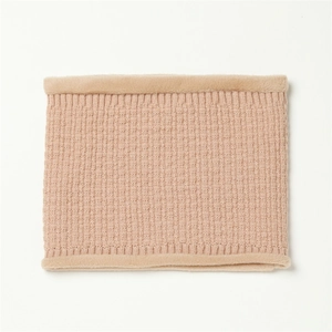 Close-up of beige knitted neck warmer showing thick texture and soft faux fur trim