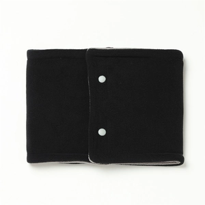 Close-up of black polar fleece neck warmer with dual white snap buttons for winter