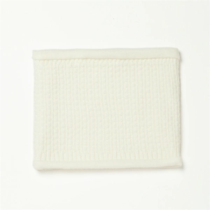 Detail of cream white waffle knit neck warmer showing thick ribbed texture and soft fabric