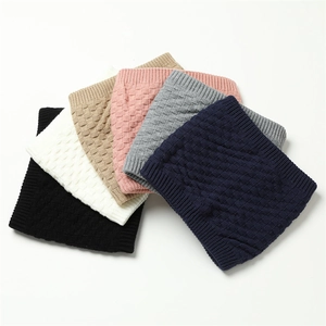 Detail of multi-color knitted snood scarves with warm grid texture and soft lining