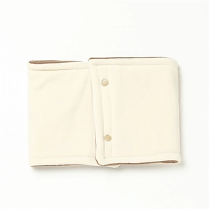 Close-up of cream fleece neck warmer with brown trim and two button fasteners