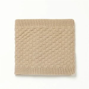 Close-up of beige knit neck warmer featuring checkered weave and ribbed elastic edges