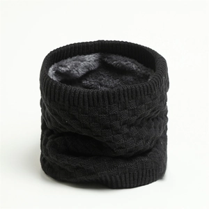 Close-up of black checkered knit fabric and thick gray fleece lining for winter neck gaiter