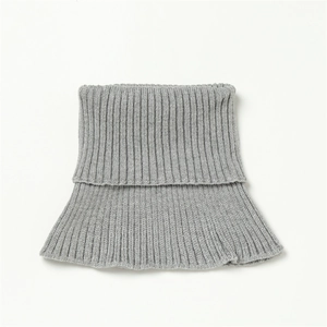 Detail of grey ribbed knit neck warmer showing thick elastic texture and stitching