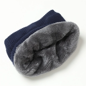 Close-up of winter knit snood with navy outer texture and thick gray fleece lining