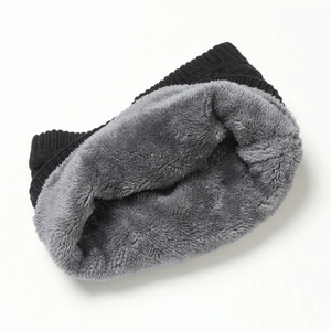 Detail of black knitted exterior with thick grey fleece lining for cold weather warmth