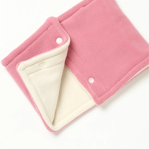 Detail of pink fleece neck warmer featuring white snap buttons and soft plush lining