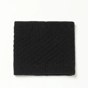 Detail of black winter knit neck warmer featuring a waffle texture and ribbed edges