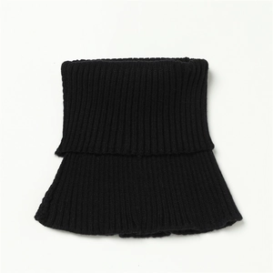 Detail of black knit neck gaiter showing the vertical ribbed texture and elastic fabric