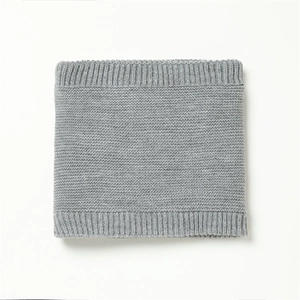 Close-up of gray knit neck warmer showing fine texture and ribbed elastic edges