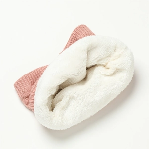 Macro detail of pink checkered knit gaiter with thick white fleece lining for winter warmth