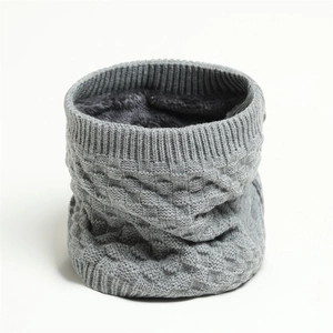 Detail of grey knitted winter neck warmer showing checkered pattern and thick fleece lining