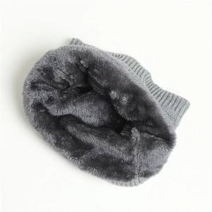 Detail view of the thick gray plush lining and knitted texture of the winter neck warmer